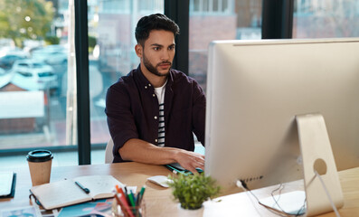 Business, computer and man working at a desk while online for research or creative work. Male...