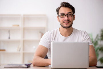 Young male employee working in the office