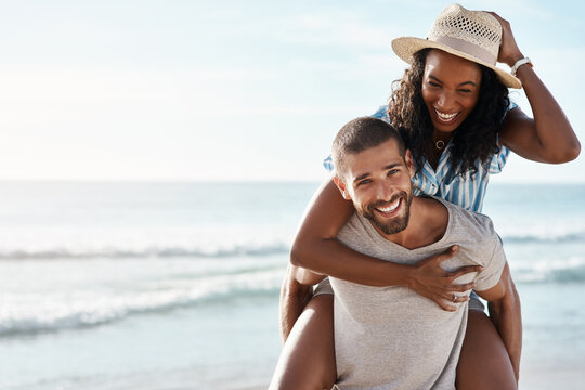 Love, ocean and piggyback, happy couple with space for mockup, blue sky and romantic summer holiday travel to beach. Romance, man and woman have fun at sea on date and tropical vacation together