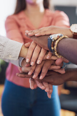 Closeup of hands together, team and support, collaboration and diversity in creative group at...
