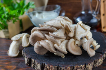 Fresh oyster mushrooms on a wooden board on the table