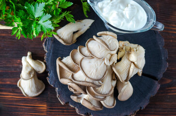 Fresh oyster mushrooms on a wooden board on the table