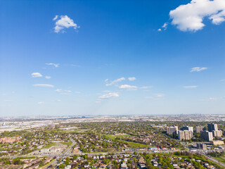Drone view, sun-drenched Brampton real estate, lush green yards, picturesque houses off Bramalea-Mayfield. Summer in Ontario at its best