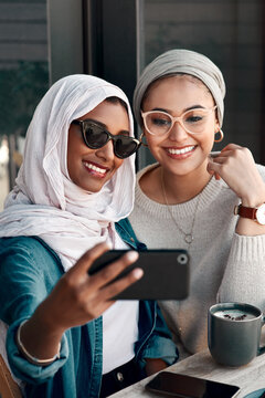 Coffee shop, couple of friends and selfie for social media, customer experience or influencer content creation. Gen z people or young islamic women, profile picture photography and cafe or restaurant
