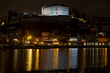Porto city at night with reflections in Douro river, Portugal