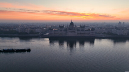 Naklejka premium Aerial view of Hungarian Parliament Building at sunrise with the Danube river, in Budapest, Hungary