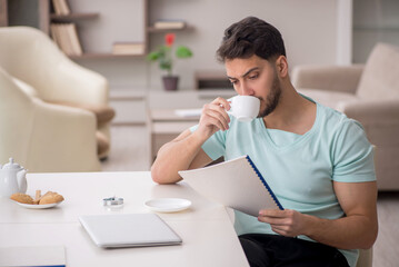 Young male freelancer working from home