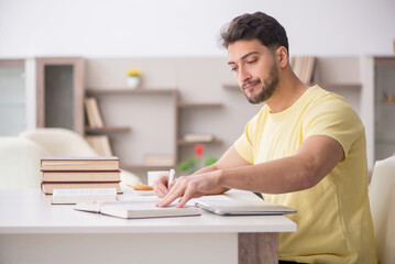 Young male student studying at home