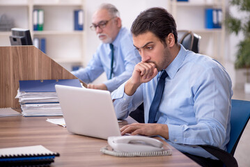 Fototapeta premium Two male colleagues working in the office
