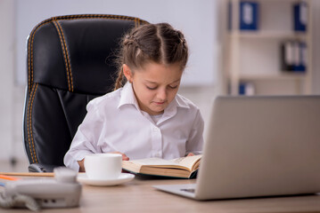 Small girl sitting in the classroom