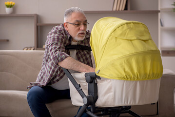 Old man looking after newborn at home