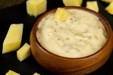 milk pineapple yogurt with pieces of pineapple and other fruits