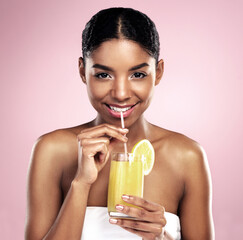 Portrait, woman and orange juice in studio for beauty, healthy nutrition or vitamin c benefits on...