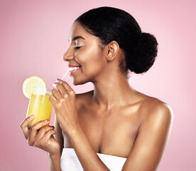 Happy woman, healthy orange juice and glass in studio, pink background and detox for weight loss. African model, citrus smoothie and vitamin c fruits for vegan nutrition, diet drink or natural beauty