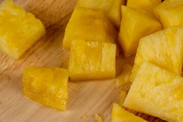 ripe pineapple of yellow-orange color cut into pieces