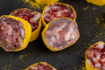 marinated in young turmeric pork sausage on black slate