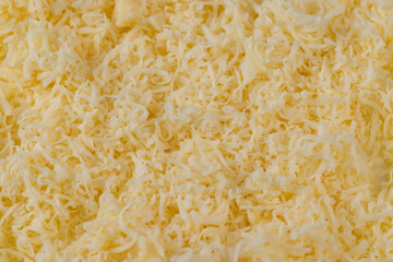 Hard cheese with holes grated into thin small slices