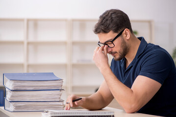 Obraz premium Young male employee sitting at workplace