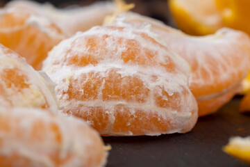Peeled tangerines on the table, close up