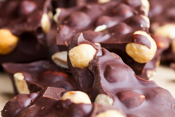 Pieces of homemade milk chocolate with lots of hazelnuts