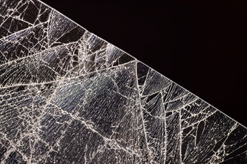 glass broken into a large number of pieces and cracks