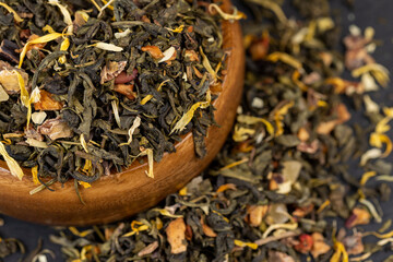 A large amount of dry green tea with pieces of fruit