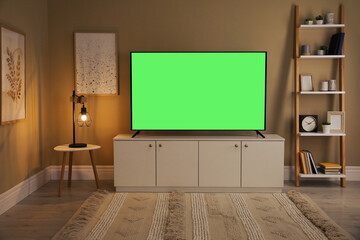 Chroma key compositing. TV with mockup green screen in room. Mockup for design