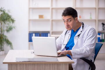 Young male doctor in telemedicine concept