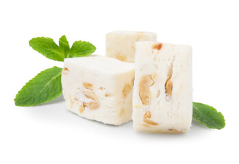 Pieces of delicious nougat and mint on white background