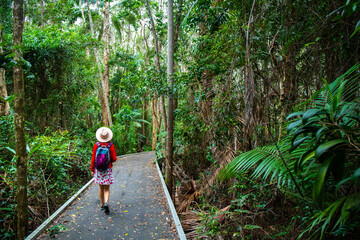 beautiful girl in hat walking through the dense bush near sunshite coast and brisbane, queensland,...