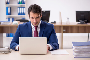 Young male employee working in the office