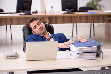 Young male employee working in the office