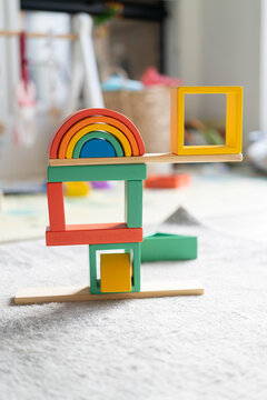 colourful children's blocks stacked into a tower balancing