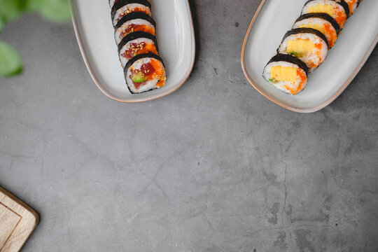 sushi background with copyspace. tuna roll and egg roll on the black table with blank .