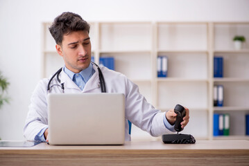 Young male doctor in telemedicine concept