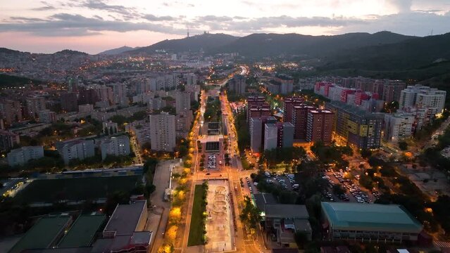 Aerial view of Barcelona city skyline at night, Streets with busy car traffic and city lights. Nou Barris District and Ronda de dalt, Catalonia, Spain