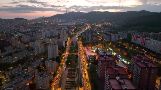 Aerial view of Barcelona city skyline at night, Streets with busy car traffic and city lights. Nou Barris District and Ronda de dalt, Catalonia, Spain