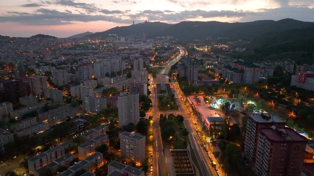 Aerial view of Barcelona city skyline at night, Streets with busy car traffic and city lights. Nou Barris District and Ronda de dalt, Catalonia, Spain