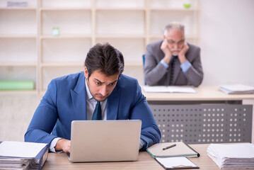 Two male colleagues working in the office