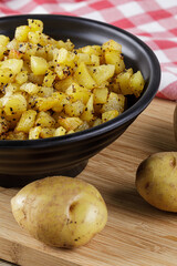 Bowl of fried Potatoes with copy space