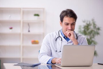 Young male doctor in telemedicine concept