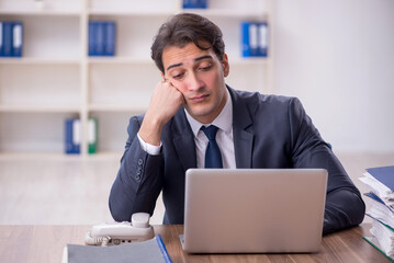 Young male employee working in the office