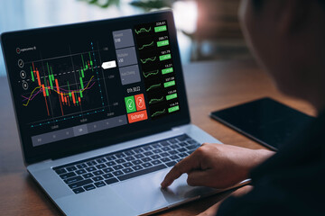 Naklejka na ściany i meble planning and strategy, Stock market, trader or investor working at home. Technical price graph and indicator, red and green candlestick chart and stock trading computer screen background.