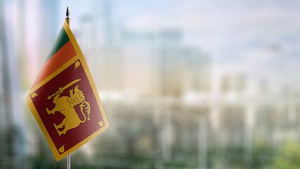 Small flags of the Sri Lanka on an abstract blurry background