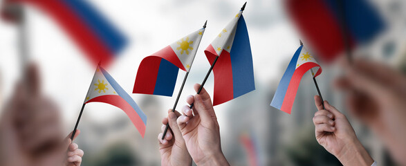 A group of people holding small flags of the Philippines in their hands - 601918798