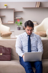 Young male employee working from home during pandemic