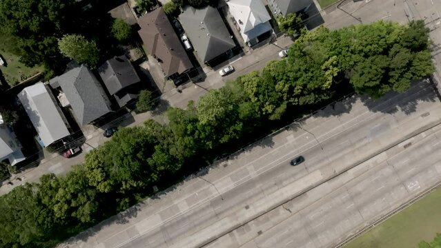 Overhead Drone Wide View Of Freeway Traffic In Baton Rouge, Louisiana With A Tilt Up To Louisiana State Capitol Building.