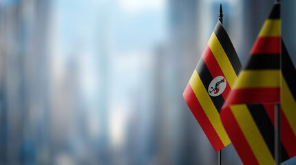 Fototapeta na wymiar Small flags of the Uganda on an abstract blurry background
