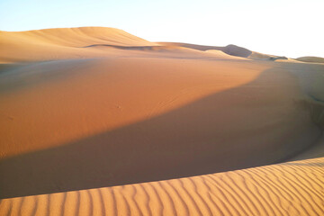 Vast sand dunes with beautiful sand ripples in the sunlight at Huacachina desert, Ica region, Peru, South America