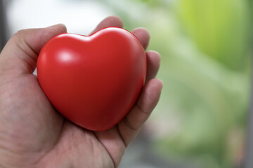 Fototapeta na wymiar Hand holding a red heart. World health day, Health care and mental health concept